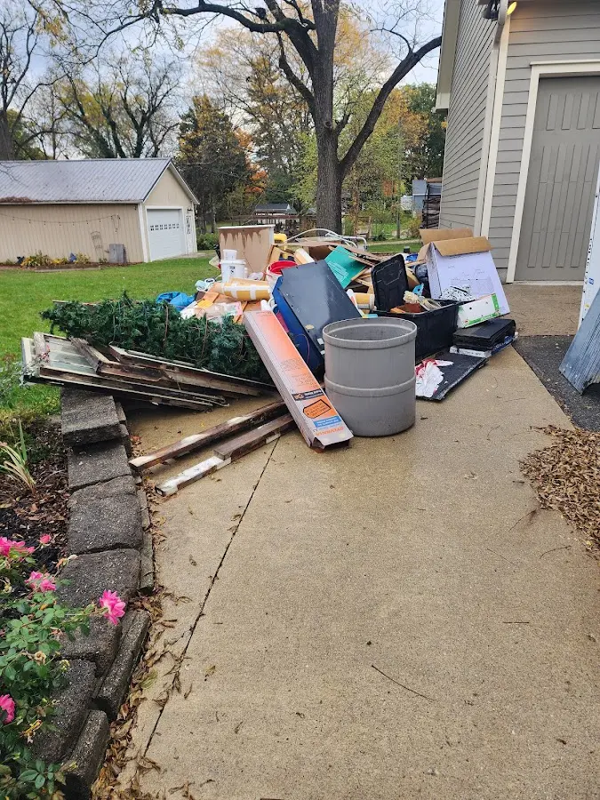 Dumpster being loaded with debris for Roofing Dumpster Rental in New Castle